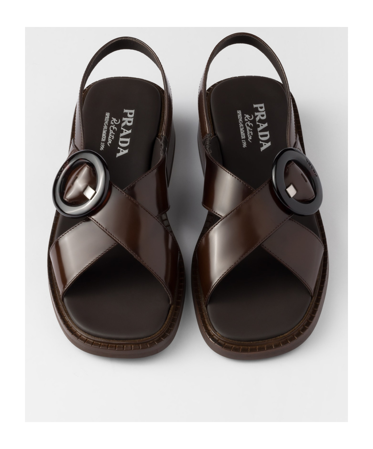 Prada Brushed Leather Crisscross Band Sandals With Plexiglas Buckle In Ochre