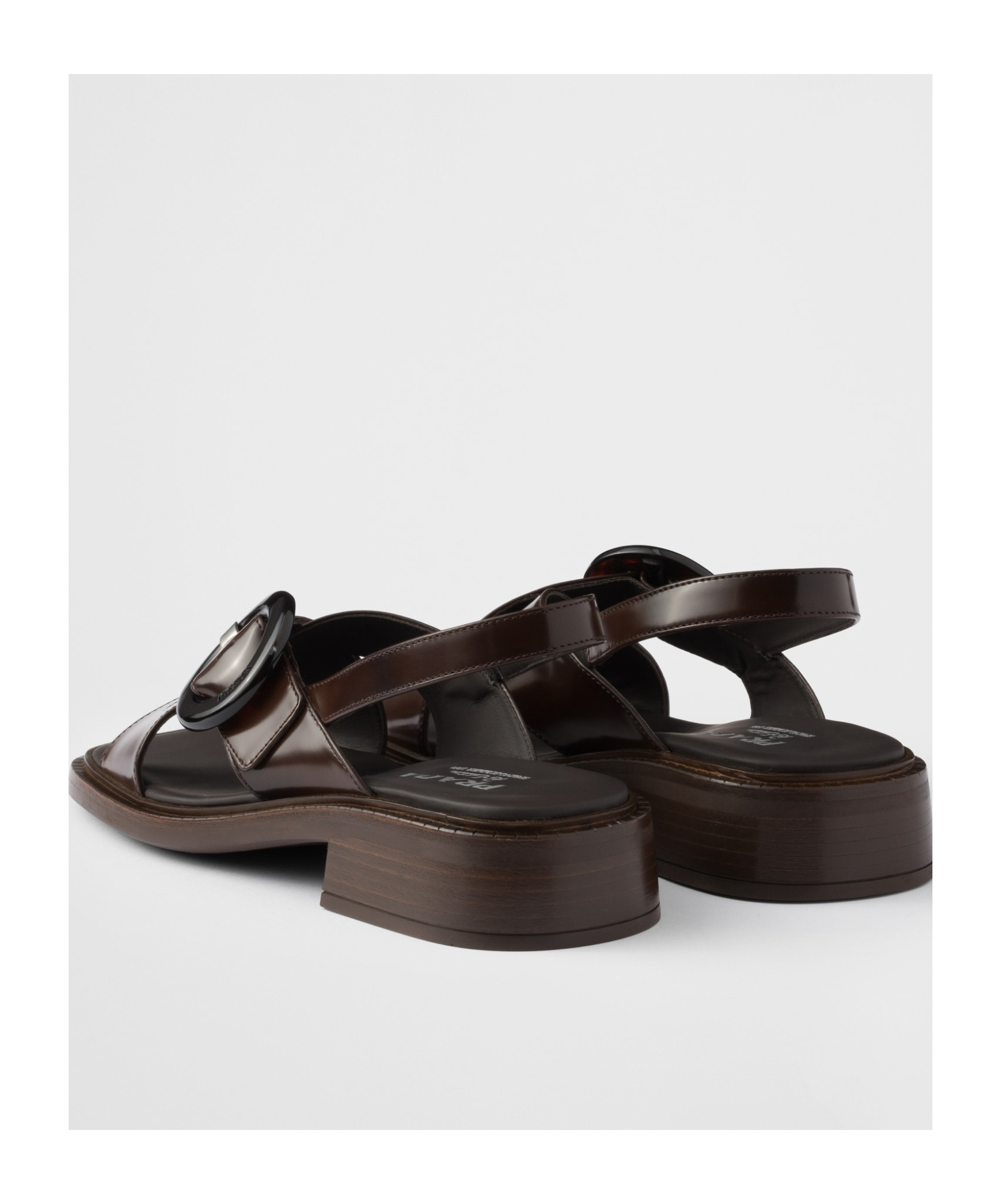 Prada Brushed Leather Crisscross Band Sandals With Plexiglas Buckle In Ochre