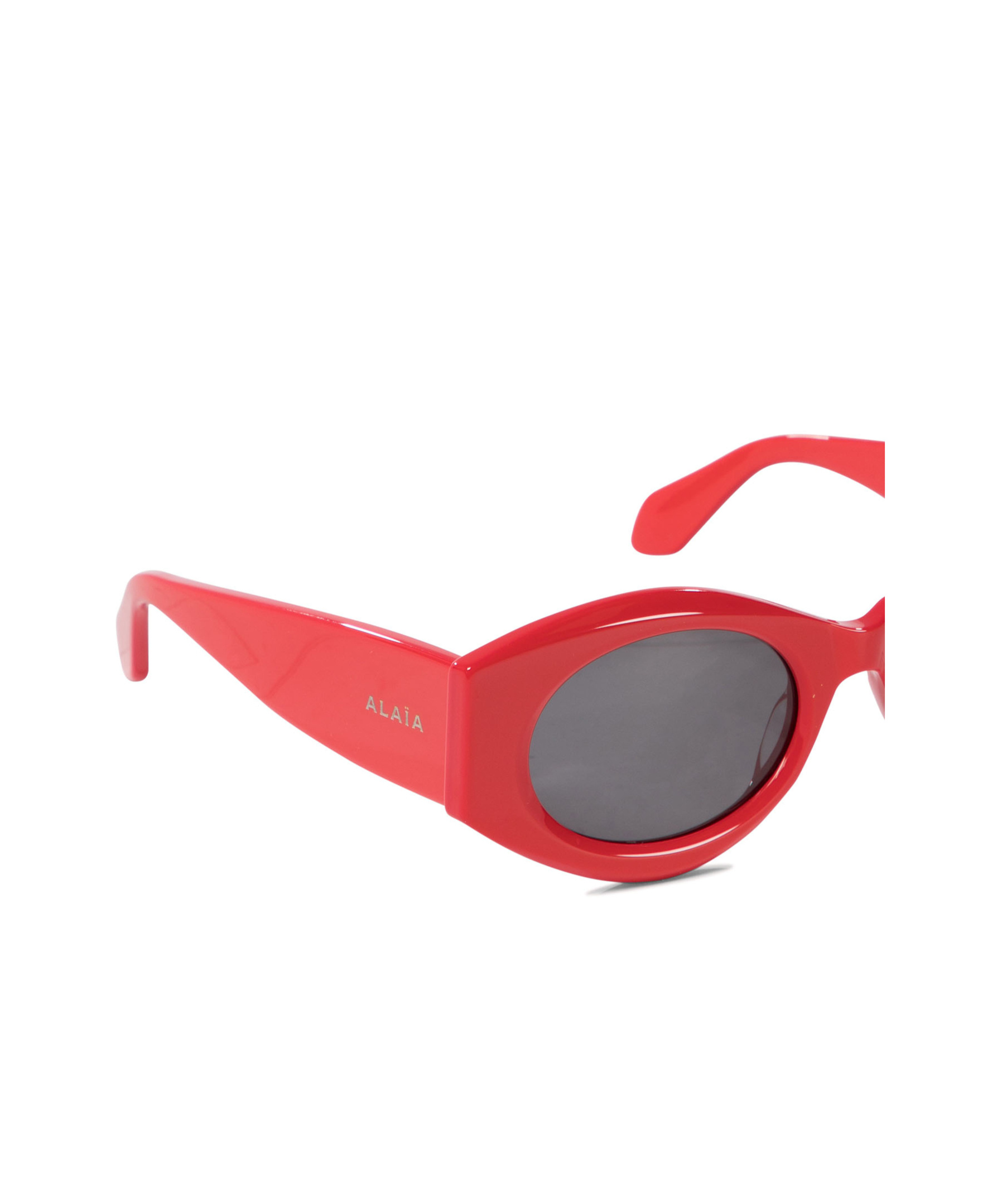 Shop Alaïa Oval Frame Sunglasses In Gray