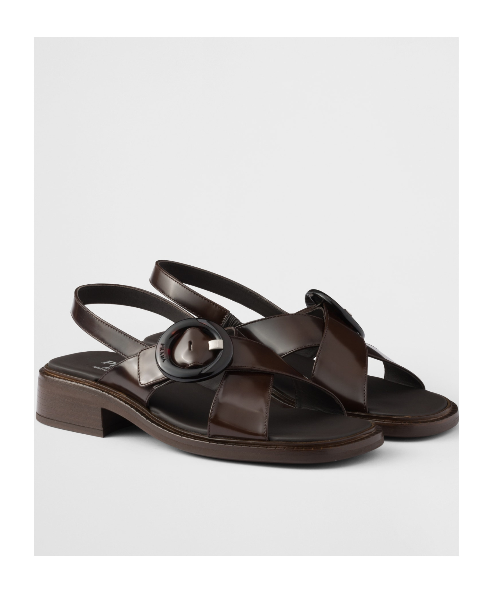 Prada Brushed Leather Crisscross Band Sandals With Plexiglas Buckle In Ochre