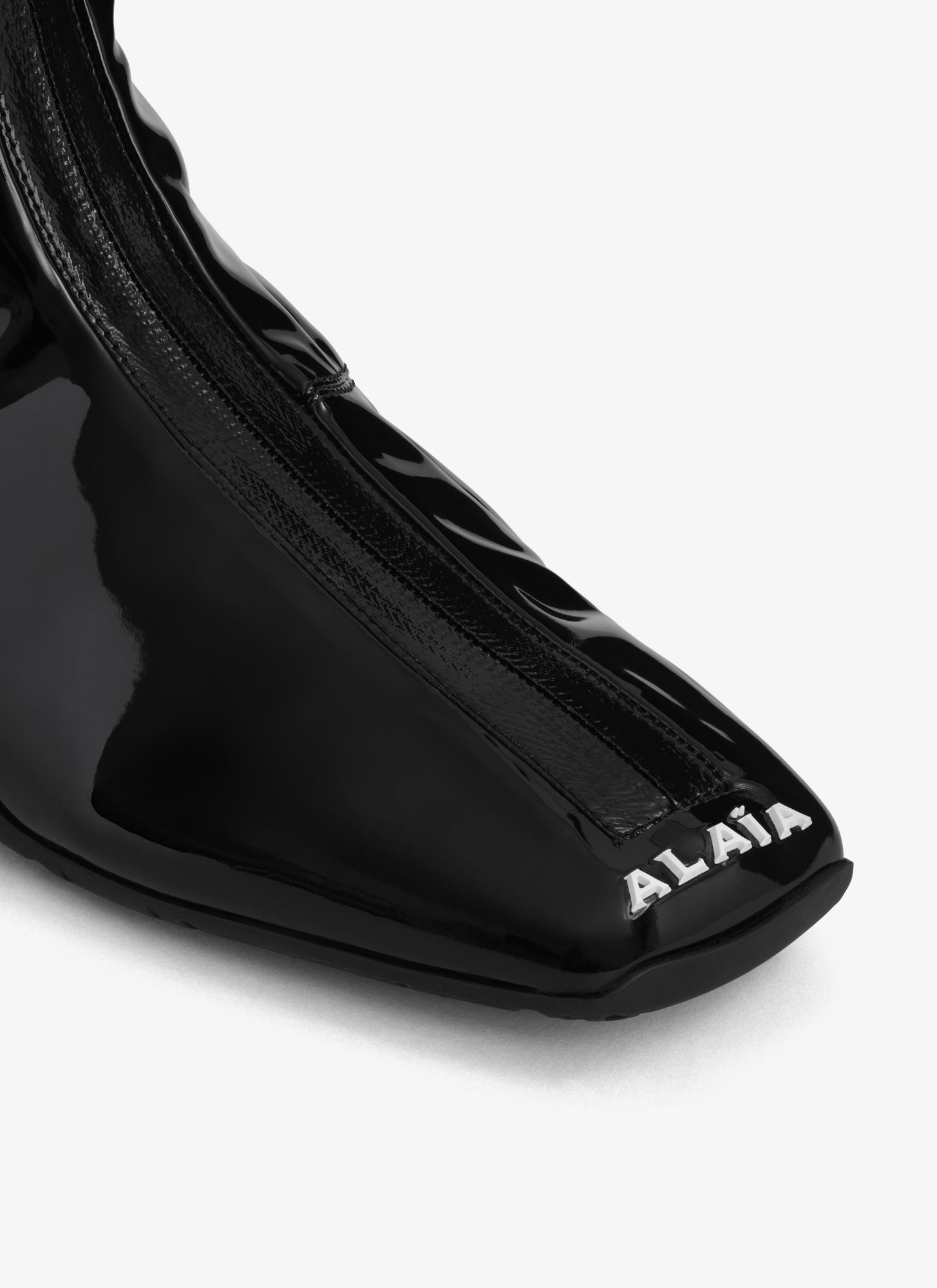 Shop Alaïa Logo-embossed Sneakers In Black