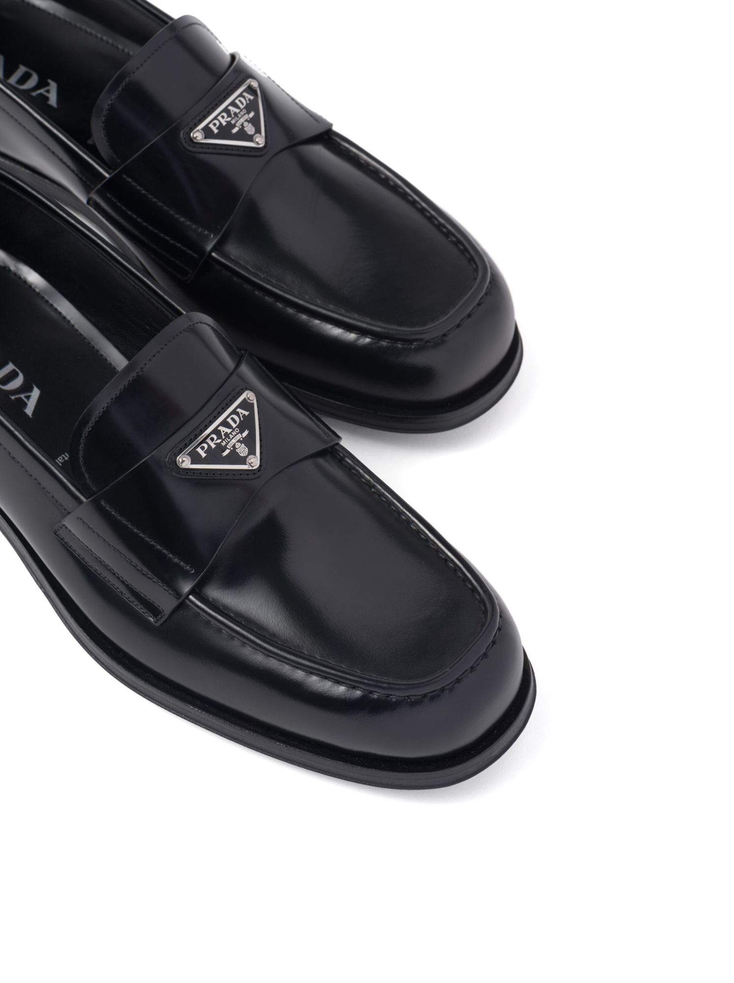 Prada Triangular Plaque Loafers In Black
