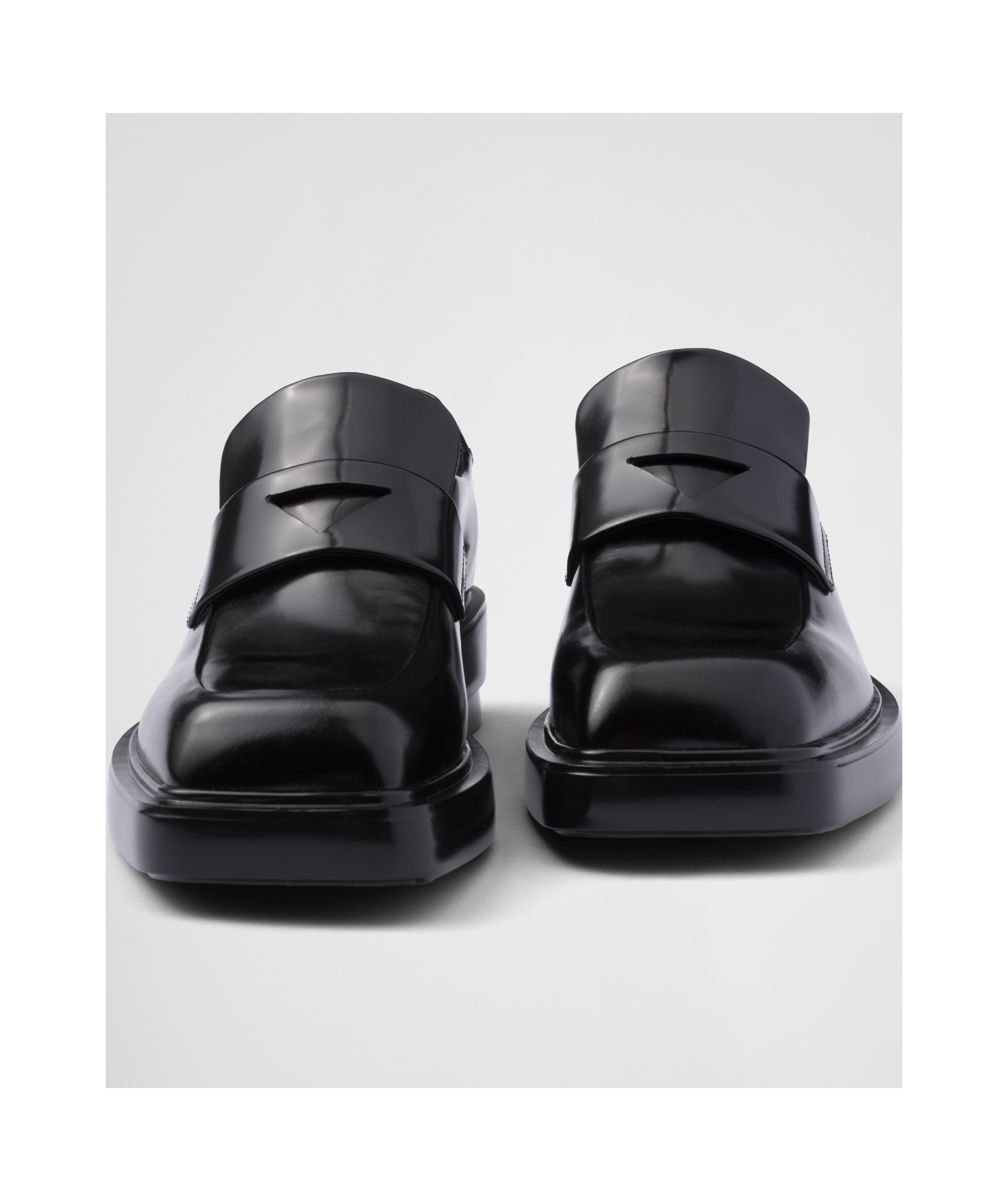 Prada Triangle Patch Leather Loafers In Black