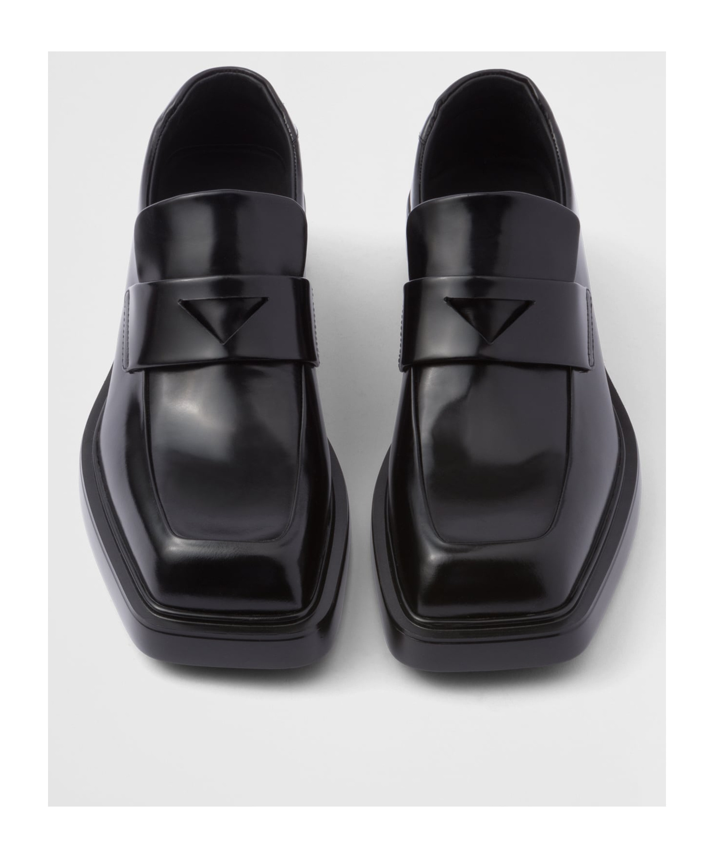 Prada Triangle Patch Leather Loafers In Black