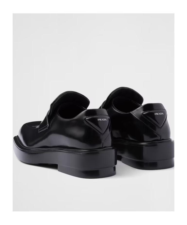 Prada Triangle Patch Leather Loafers In Black